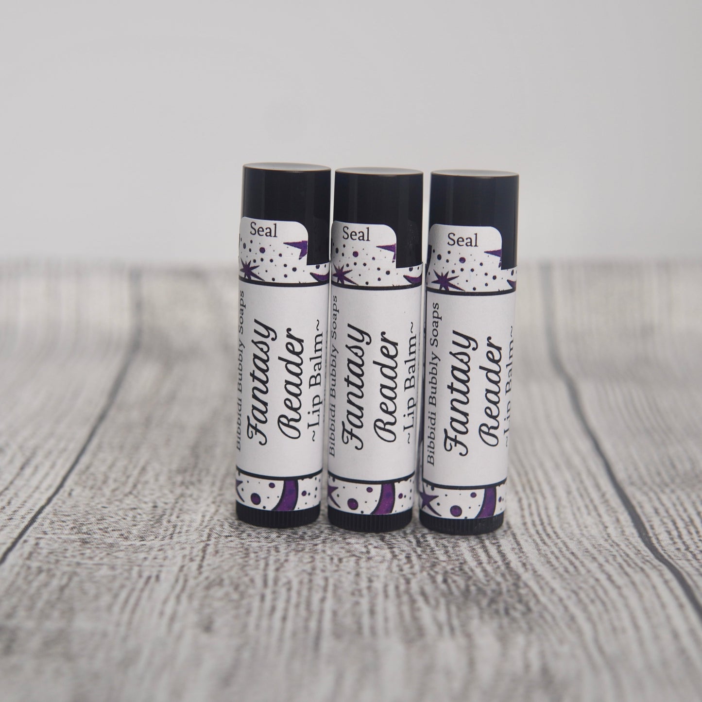 Fantasy reader labeled lip balm with ingredient list.