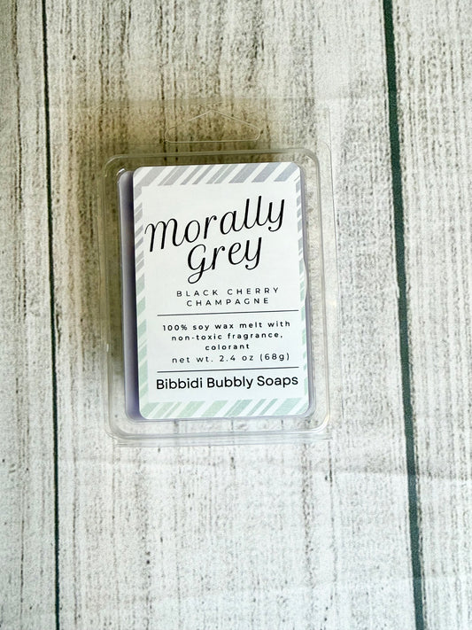 Wax melt packaging labeled 'Morally Grey' on a wooden surface
